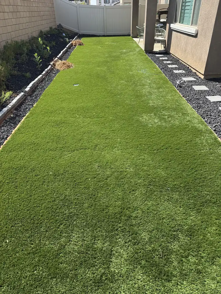 Clean Inland Empire turf yard bordered by gravel and desert plants